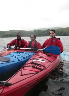 Travel by kayak on one of the Lake District many lakes; this one is Coniston Water.
